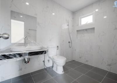 Modern bathroom with marble tiles and wall-mounted fixtures