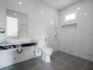 Modern bathroom with marble tiles and wall-mounted fixtures