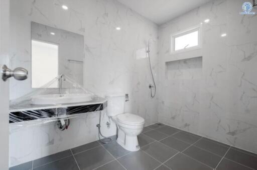 Modern bathroom with marble tiles and wall-mounted fixtures