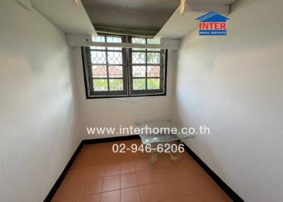Small empty room with tiled floor and white walls
