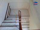Well-maintained staircase with wooden handrails and tiled steps