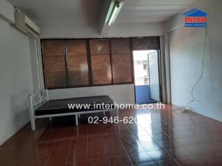 Spacious living room with large windows and air conditioning unit in an apartment