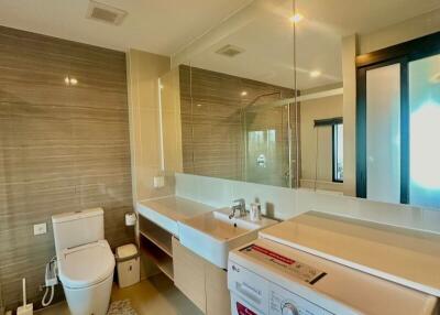 Modern bathroom with integrated laundry area