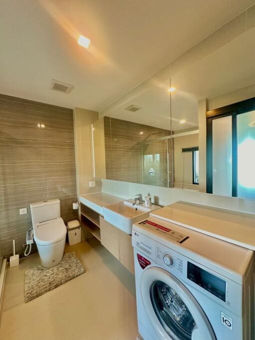 Modern bathroom with integrated laundry area