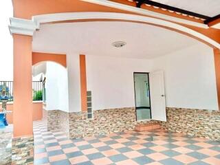 Elegant home entrance with checkerboard flooring and stone wall accents