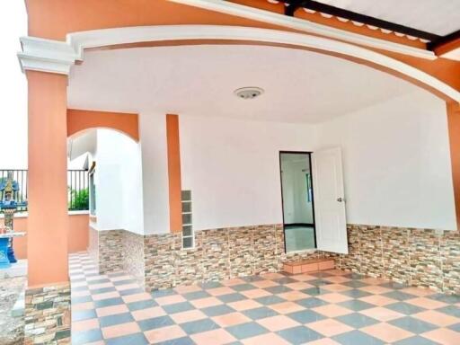 Elegant home entrance with checkerboard flooring and stone wall accents