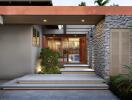 Modern home entrance with stone walls and water feature