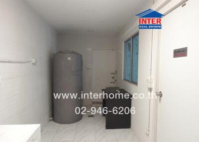 Compact utility room with water heater and washing facilities