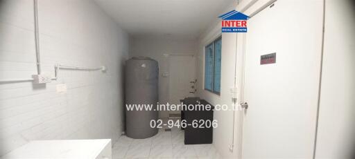 Compact utility room with water heater and washing facilities