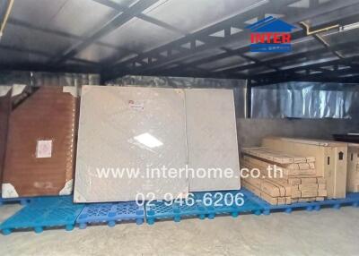 Spacious warehouse interior with packed goods and a person