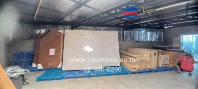 Spacious warehouse interior with packed goods and a person