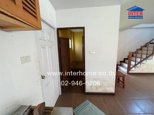 Spacious entryway with staircase and hallway inside a residential house