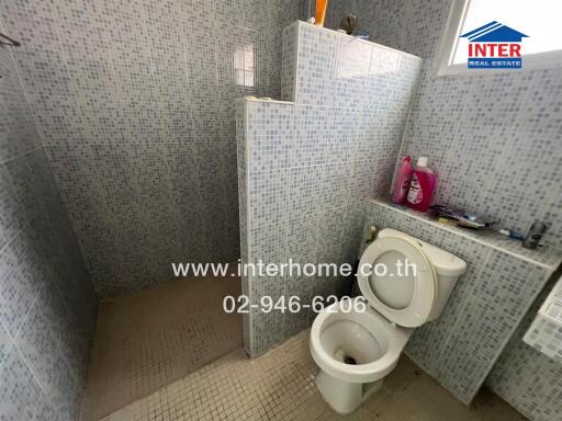 Compact bathroom with tiled walls and modern fixtures