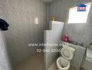 Spacious bathroom with modern tiles and essential fixtures