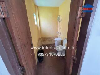 Compact bathroom with wooden doors, yellow walls, and modern fixtures