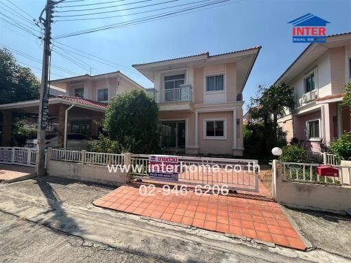 Elegant two-story residential house with a pink facade and private parking