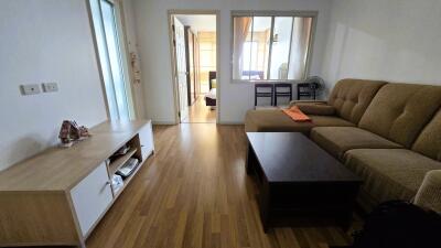 Spacious living room with wooden flooring and large sofa