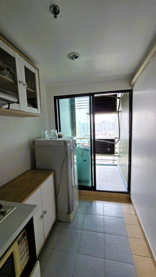 Small modern kitchen with galley layout and balcony access