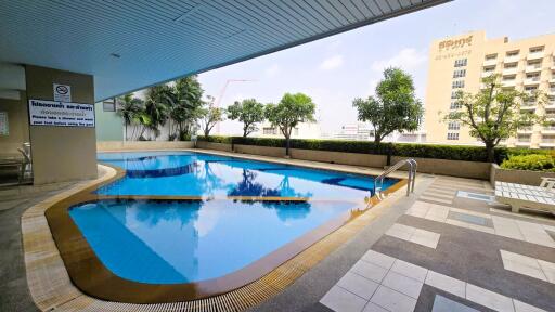 Spacious outdoor swimming pool with ample seating area