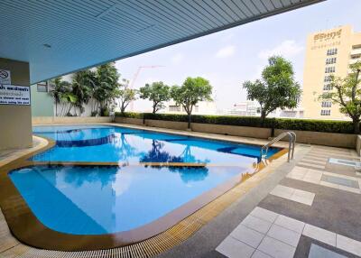 Spacious outdoor swimming pool with ample seating area