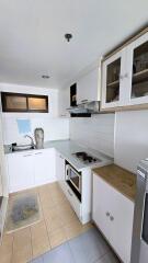 Modern kitchen with white cabinetry and stainless steel appliances