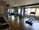 Spacious residential gym with modern equipment and large windows