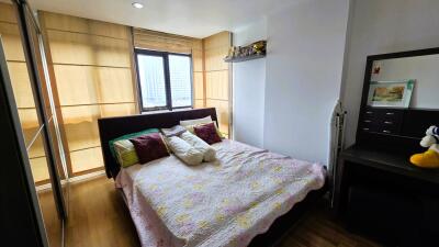 Cozy bedroom with large window and wooden accents