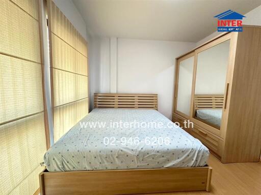 Bright and cozy bedroom with large bed and spacious wardrobe
