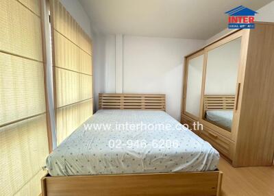 Bright and cozy bedroom with large bed and spacious wardrobe