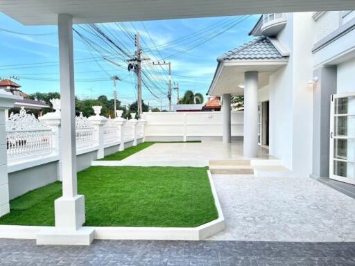 Exterior view of a modern house with manicured lawn and elegant architecture