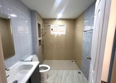 Spacious modern bathroom with light blue tiles