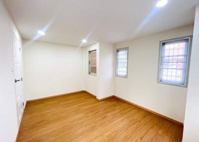 Spacious and well-lit empty bedroom with hardwood floors