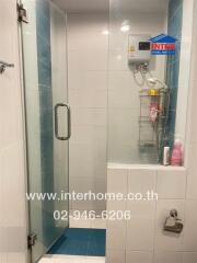 Modern bathroom with glass shower and white tiled walls