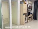 Compact interior hallway with storage solutions and visible rooms in an apartment