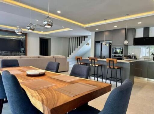 Spacious modern dining area with adjacent kitchen