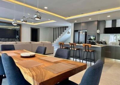 Spacious modern dining area with adjacent kitchen