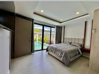 Modern bedroom with direct pool access through sliding glass doors
