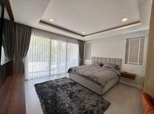 Spacious and modern bedroom with natural lighting