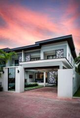 Modern two-story house at dusk with picturesque sky