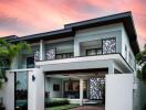 Modern two-story house at dusk with picturesque sky