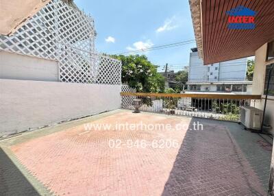 Spacious private outdoor area with patterned tiling and covered section