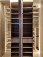 Spacious bedroom walk-in closet with custom shelving