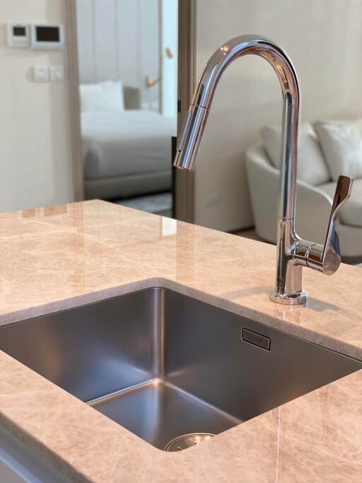 Modern kitchen sink with a stylish faucet on a marble countertop