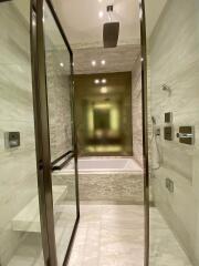 Modern bathroom with glass shower enclosure and bathtub