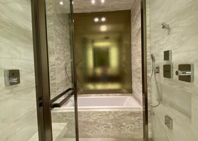 Modern bathroom with glass shower enclosure and bathtub