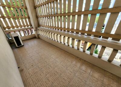 Spacious balcony with tiled flooring and latticed privacy screens