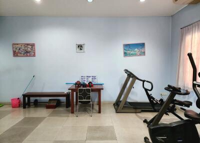 Home gym with fitness equipment and adequate lighting