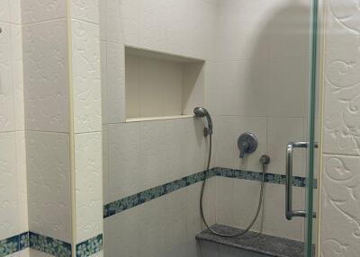 Compact tiled bathroom with shower