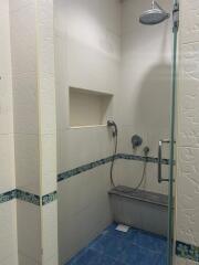 Compact tiled bathroom with shower