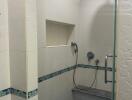 Compact tiled bathroom with shower